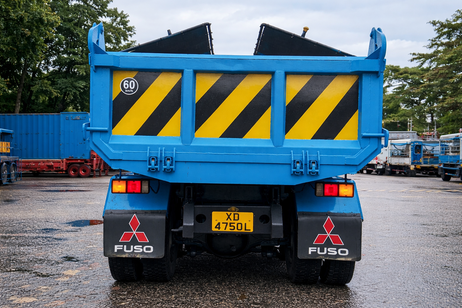 Blue Fuso Truck On Wet Asphalt